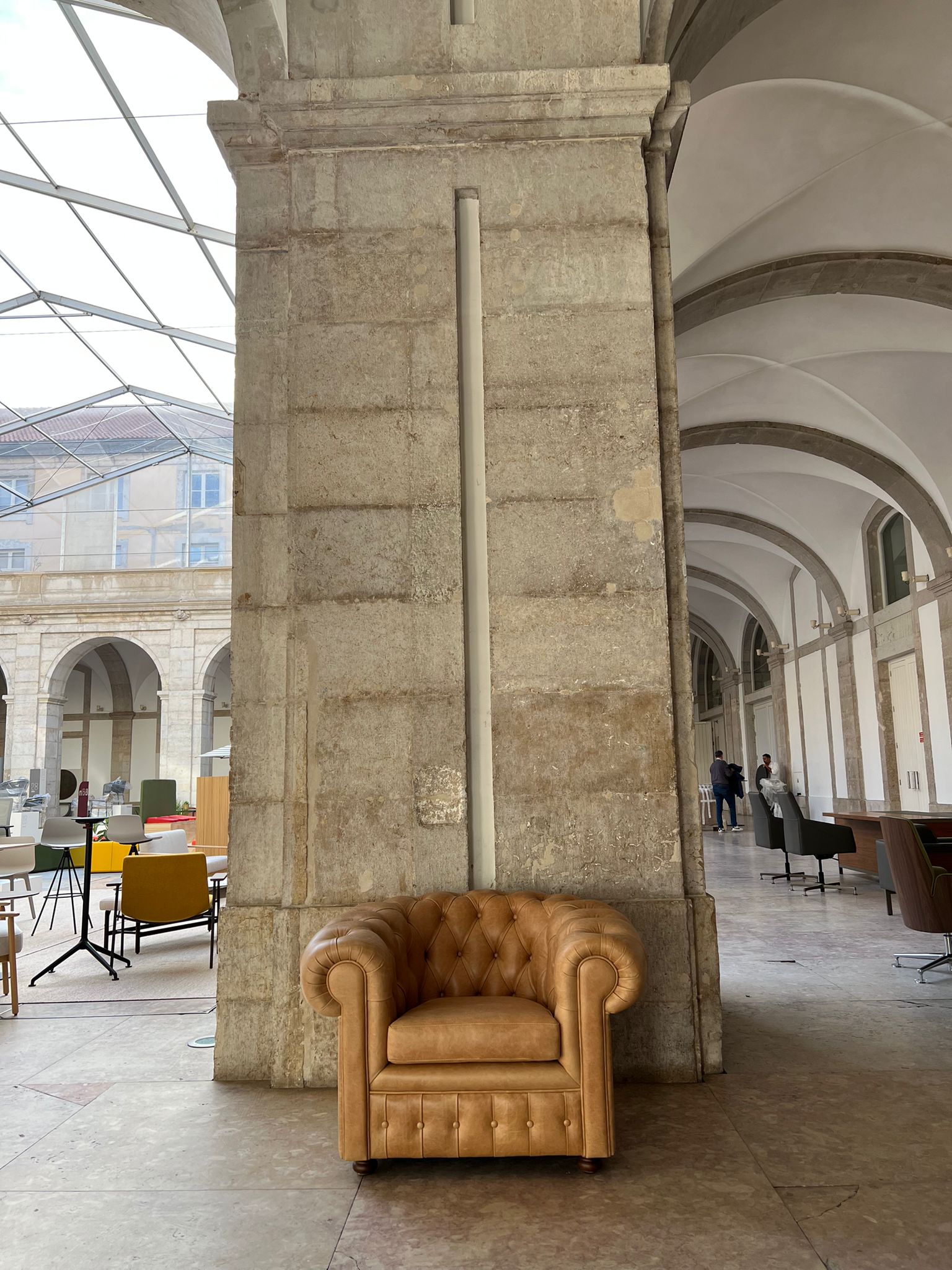 Image of an armchair under a pillar at a furniture exhibition